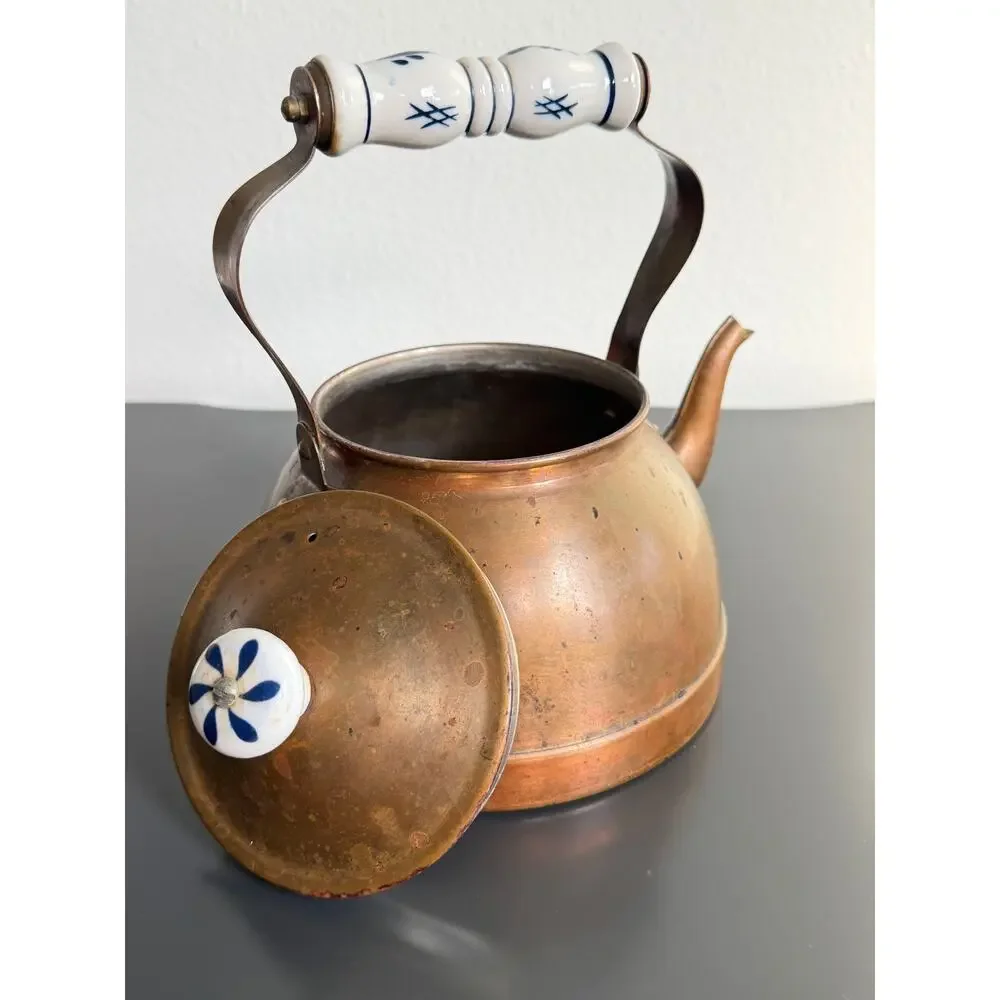 Vintage copper tea kettle with hand-painted blue and white porcelain handle lid
